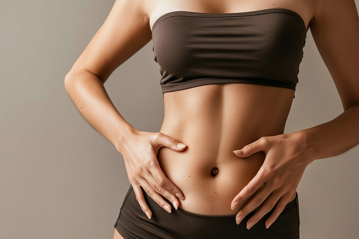 Woman touching stomach in studio with liposuction mockup