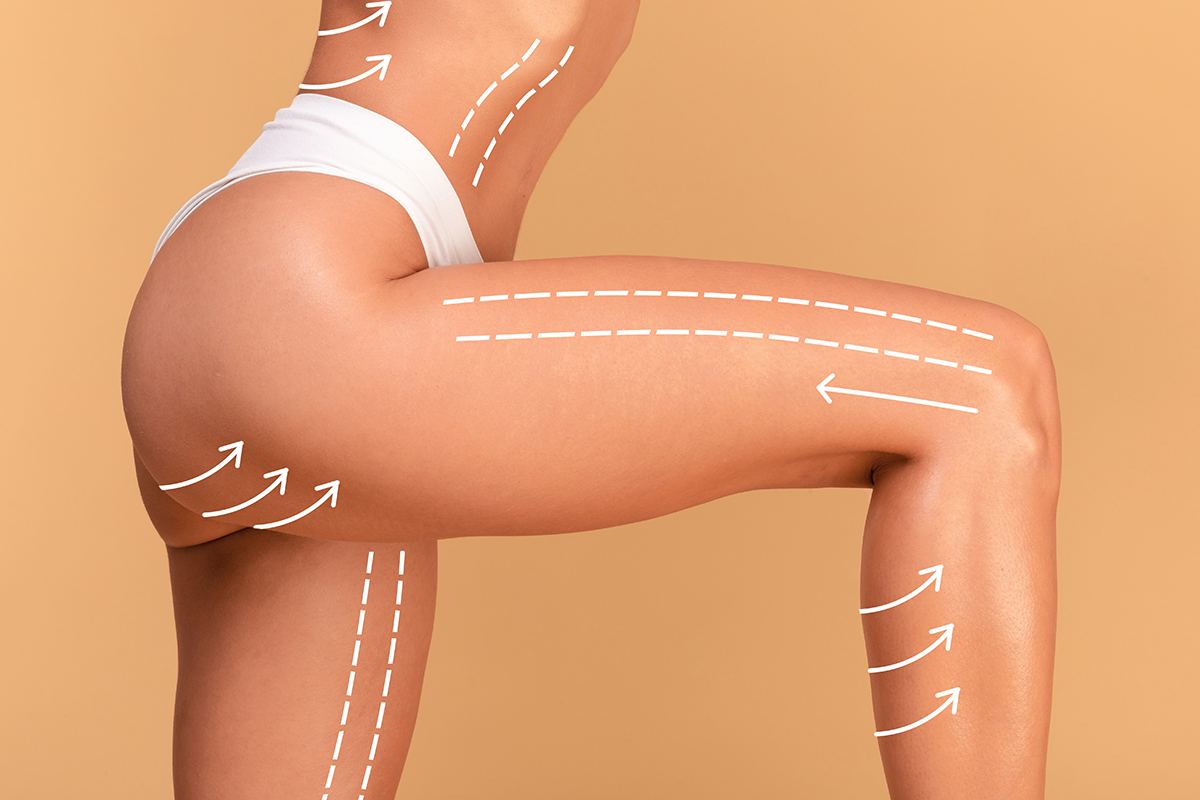 Closeup cropped shot of young woman in white panties posing with massage lines and arrows on her body
