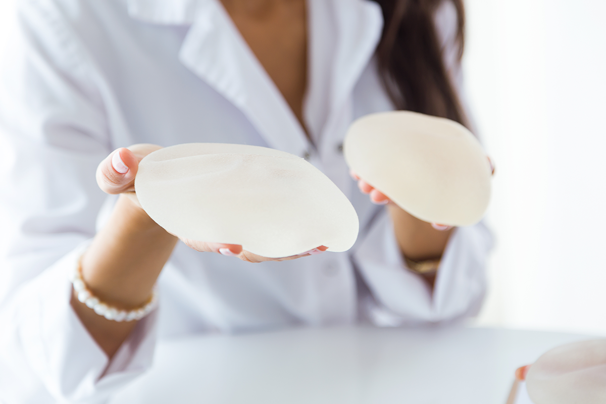 Female doctor choosing mammary prosthesis in the office