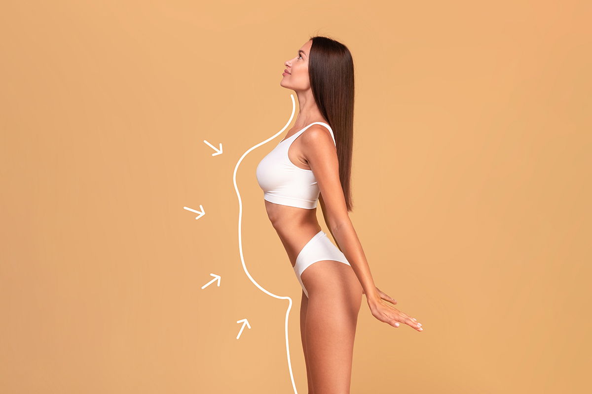Side view of slim lady in white lingerie with perfect body shape posing with outlines and arrows